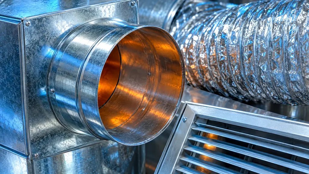 A macro close-up of shiny galvanized sheet metal HVAC ducts with a round collar, a flexible duct and a vent register, cool blue reflections and a warm orange glow inside the duct